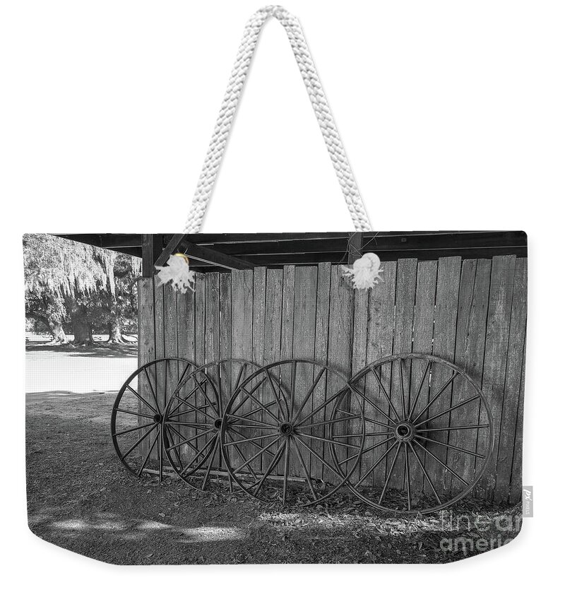 Black And White Weekender Tote Bag featuring the photograph Old Wagon Wheels Black And White by Kathy Baccari