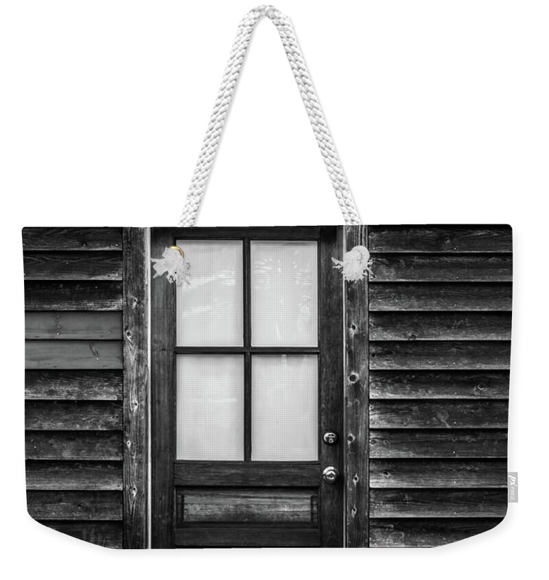 Terry D Photography Weekender Tote Bag featuring the photograph Old Wood Door and Light Black and White by Terry DeLuco