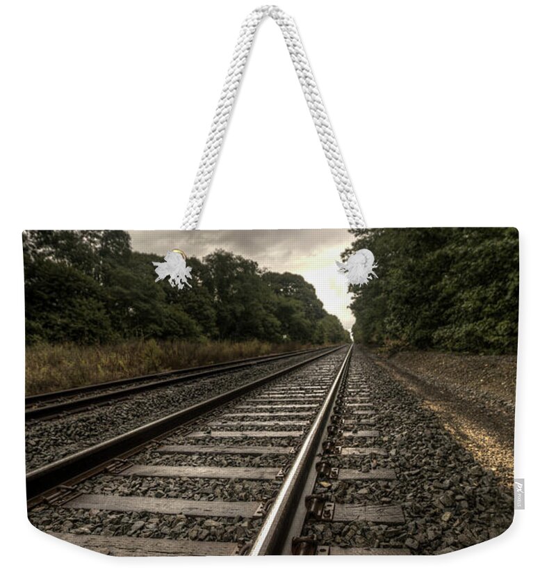 Tracks Weekender Tote Bag featuring the photograph One way home by Steve Gravano