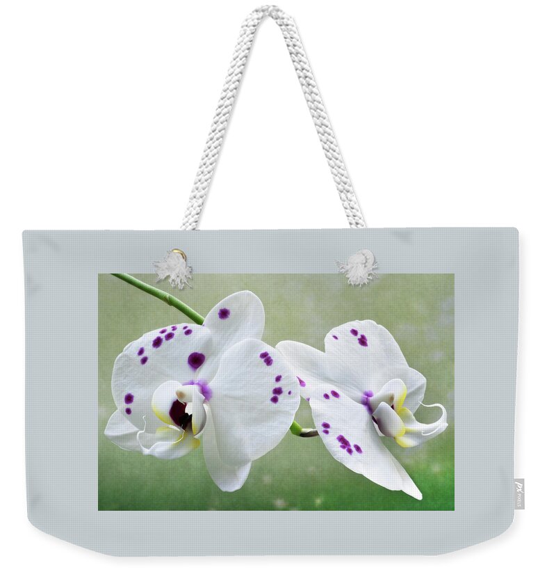 Orchids Weekender Tote Bag featuring the photograph Orchids With Purple Specks by Terence Davis