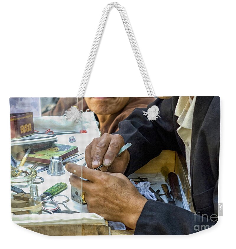 Asian Weekender Tote Bag featuring the photograph Outdoor repair of clockwork by Patricia Hofmeester
