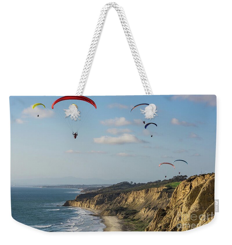 Beach Weekender Tote Bag featuring the photograph Paragliders at Torrey Pines Gliderport Over Black's Beach by David Levin