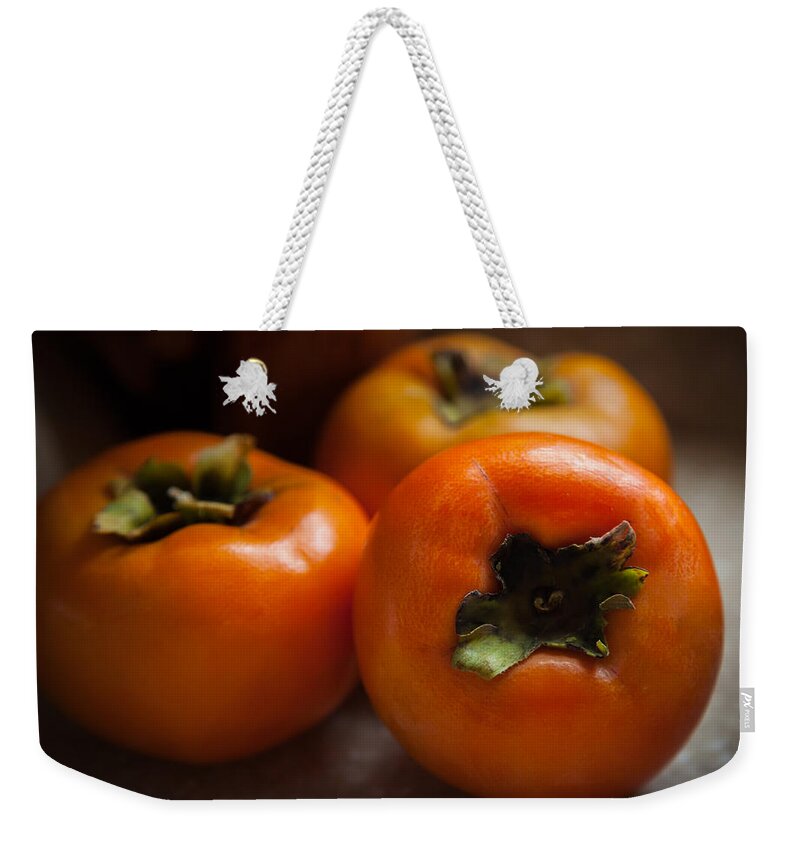 Persimmons Weekender Tote Bag featuring the photograph Persimmons by Karen Wiles