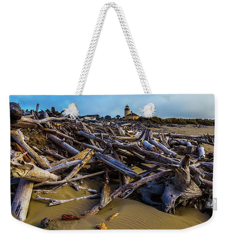Romantic Coquille River Lighthouse Weekender Tote Bag featuring the photograph Piles Of Driftwood by Garry Gay