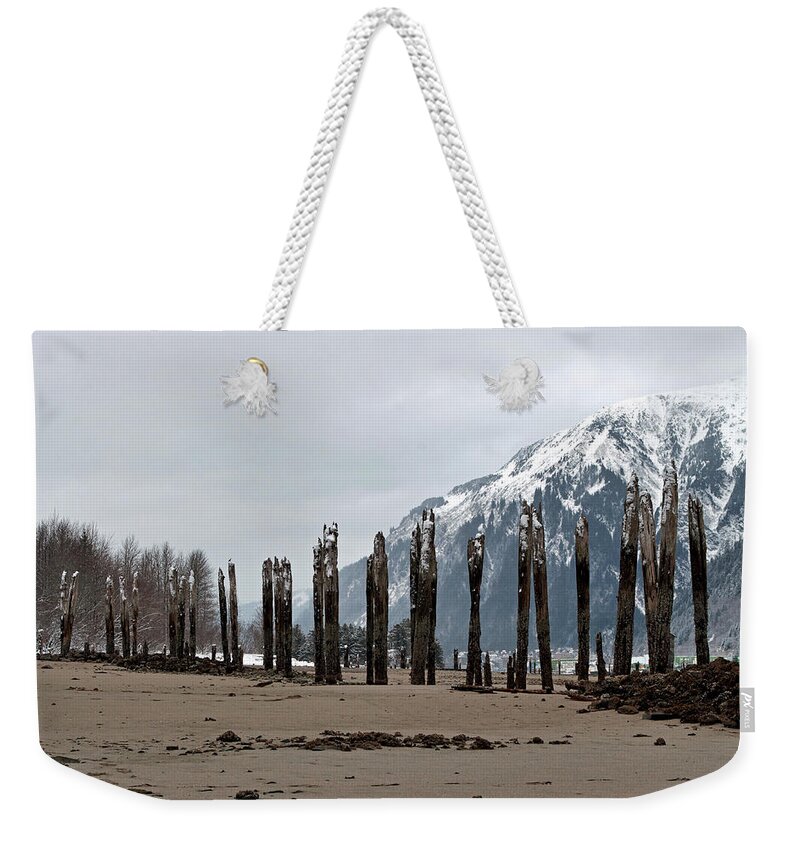 Abandoned Weekender Tote Bag featuring the photograph Pilings at Sandy Beach - Low Tide by Cathy Mahnke