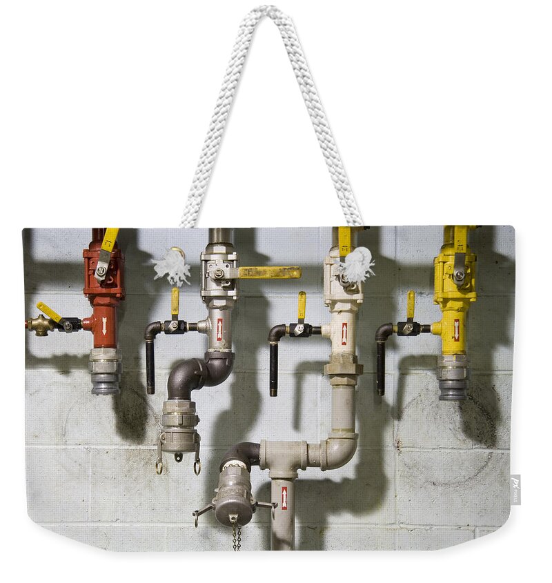 Pipes Weekender Tote Bag featuring the photograph Pipes and valves by Alexey Stiop