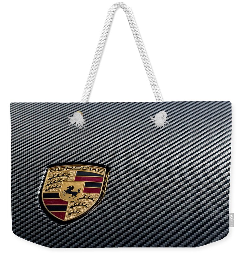 Porsche Weekender Tote Bag featuring the photograph Porsche logo on carbon front boot lid by 2bhappy4ever