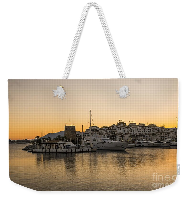 Puerto Banus Weekender Tote Bag featuring the digital art Puerto Banus in Marbella at sunset. by Perry Van Munster