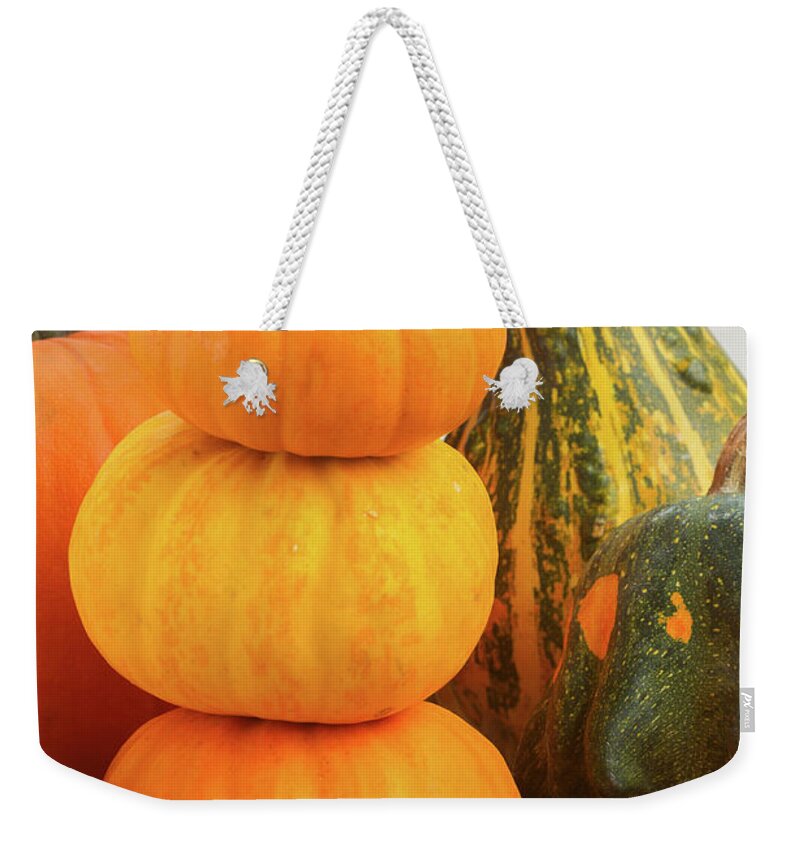 Pumpkin Weekender Tote Bag featuring the photograph Pumpkins on Table by Anastasy Yarmolovich