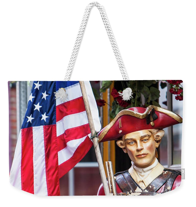 Boston Weekender Tote Bag featuring the photograph Red Coat holding the American flag by Jason Hughes