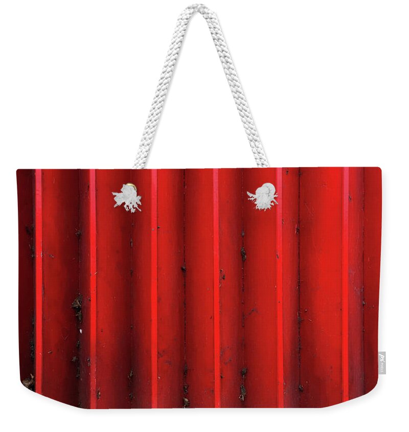 Background Weekender Tote Bag featuring the photograph Red expanding metal by Tom Gowanlock