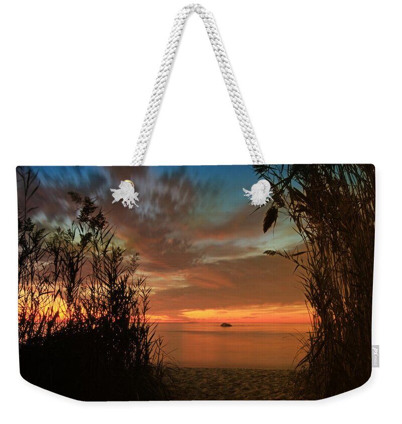 Red Weekender Tote Bag featuring the photograph Red Sunset by Darius Aniunas
