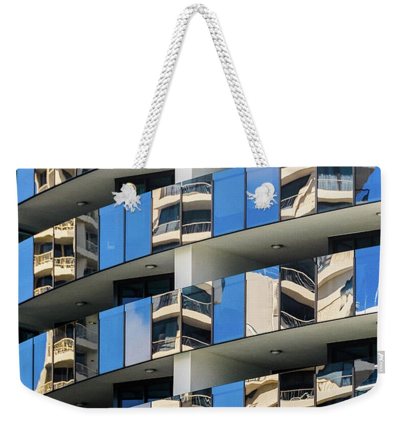 Building Weekender Tote Bag featuring the photograph Reflecting Surfers 1 by Werner Padarin