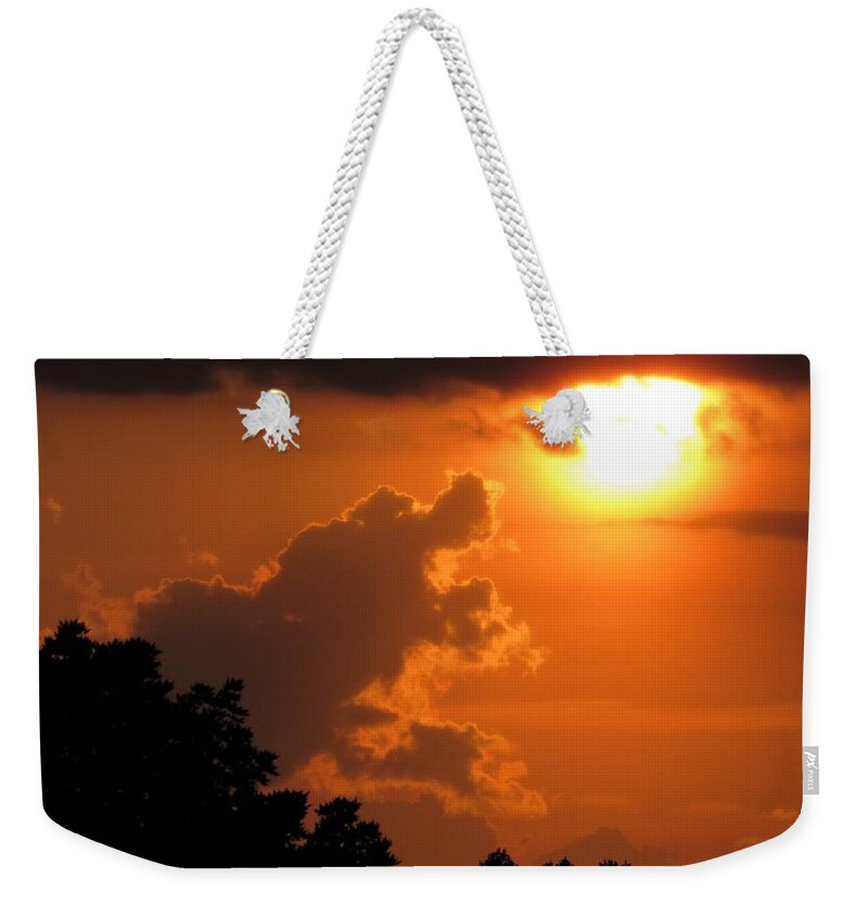Sunset Weekender Tote Bag featuring the photograph Retrieving The Sun by Chip Gilbert
