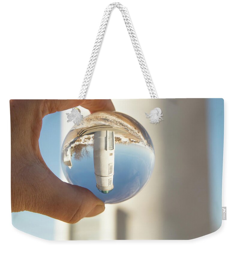 America Weekender Tote Bag featuring the photograph Robert H Manning Lighthouse, Empire, Michigan in winter reflecti by Karen Foley