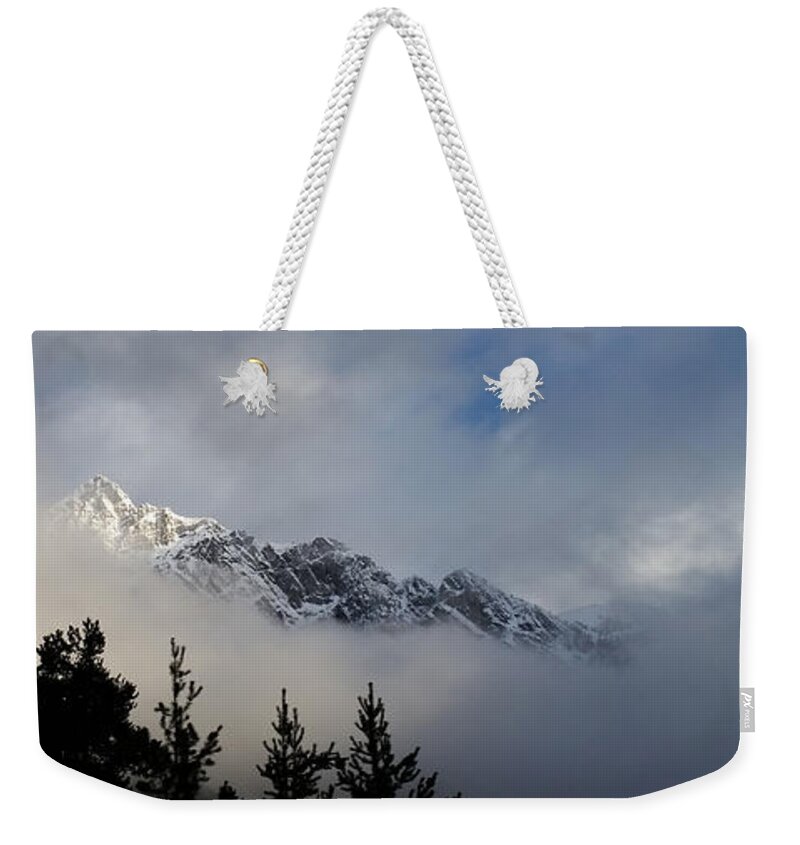 Mountains Weekender Tote Bag featuring the photograph Rockies in the Clouds. by Ellery Russell