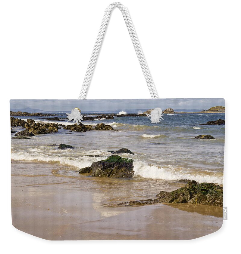 Rocks Weekender Tote Bag featuring the photograph Rocks, waves, sand and sky reflection. by Elena Perelman