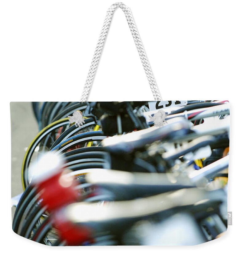 Row Weekender Tote Bag featuring the photograph Row of race bikes 4 by Micah May