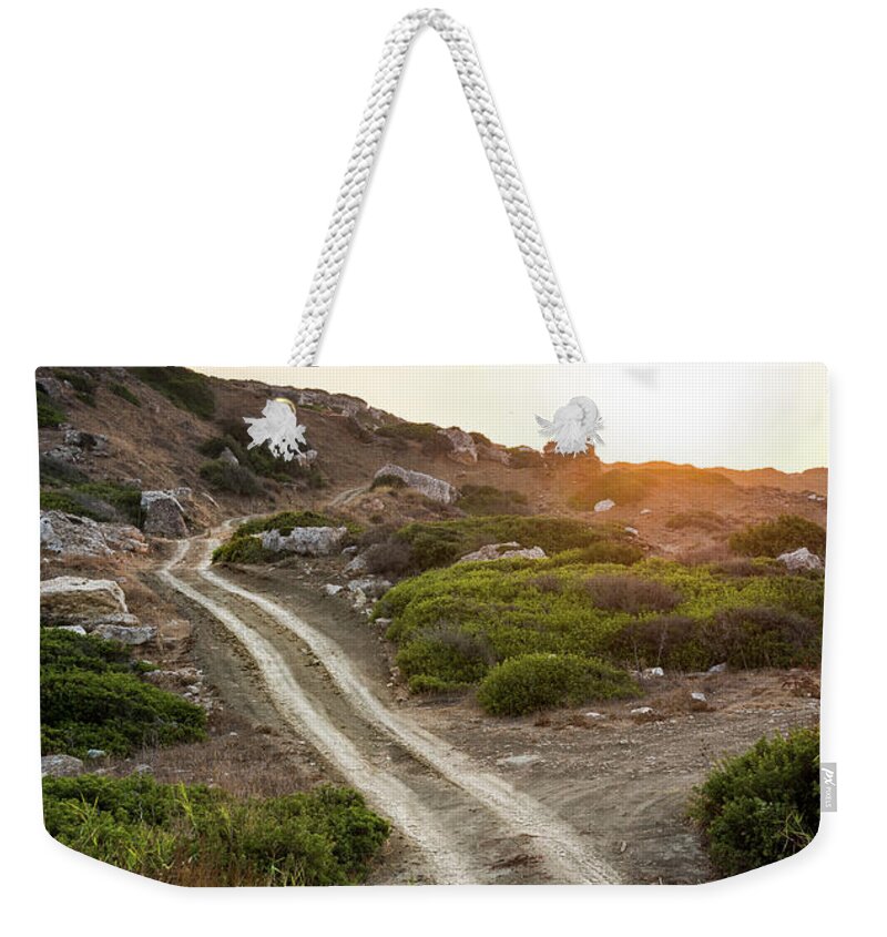 Heaven Weekender Tote Bag featuring the photograph Rural country road and dramatic susnet by Michalakis Ppalis
