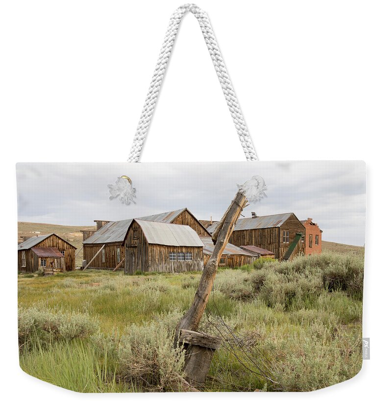 Abandoned Weekender Tote Bag featuring the photograph Rustic wooden structures in Bodie, California by Karen Foley