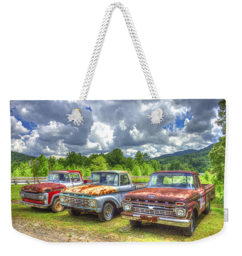 Reid Callaway Antique Ford Trucks Weekender Tote Bag featuring the photograph Rusty Brothers Ford Trucks 1960 1964 1966 Antique Automotive Art by Reid Callaway