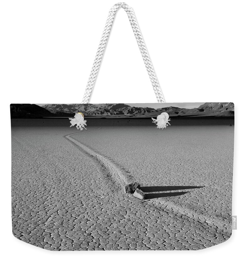 Death Valley Weekender Tote Bag featuring the photograph Sailing Stones on the Racetrack Playa by Rick Pisio