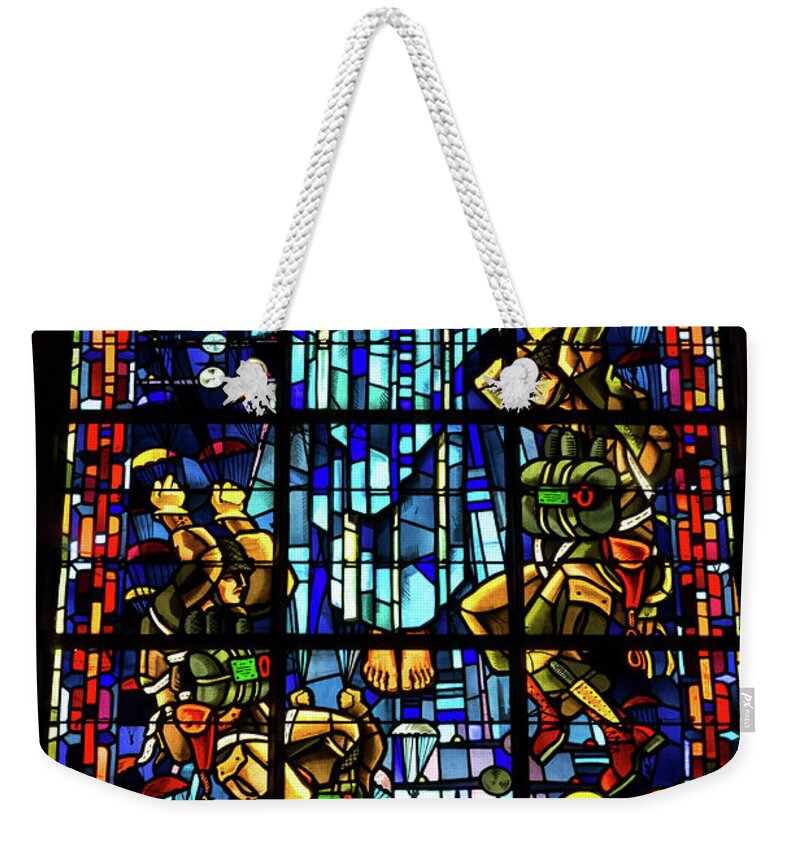 Sainte-mere-eglise Weekender Tote Bag featuring the photograph Sainte-Mere-Eglise Paratrooper Tribute Stained Glass Window by John Daly