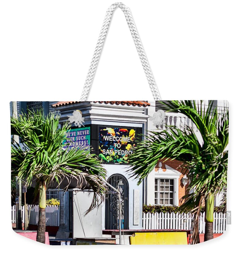 Ambergris Caye Weekender Tote Bag featuring the photograph San Pedro Town Plaza by Lawrence Burry