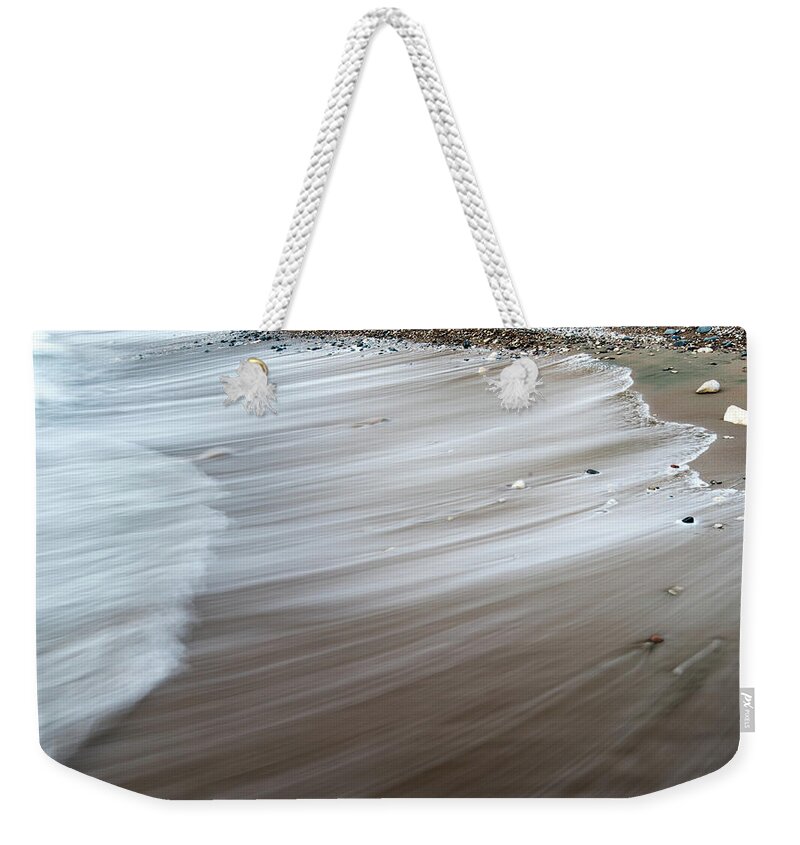 Coastline Weekender Tote Bag featuring the photograph Sea water nature abstract background by Michalakis Ppalis