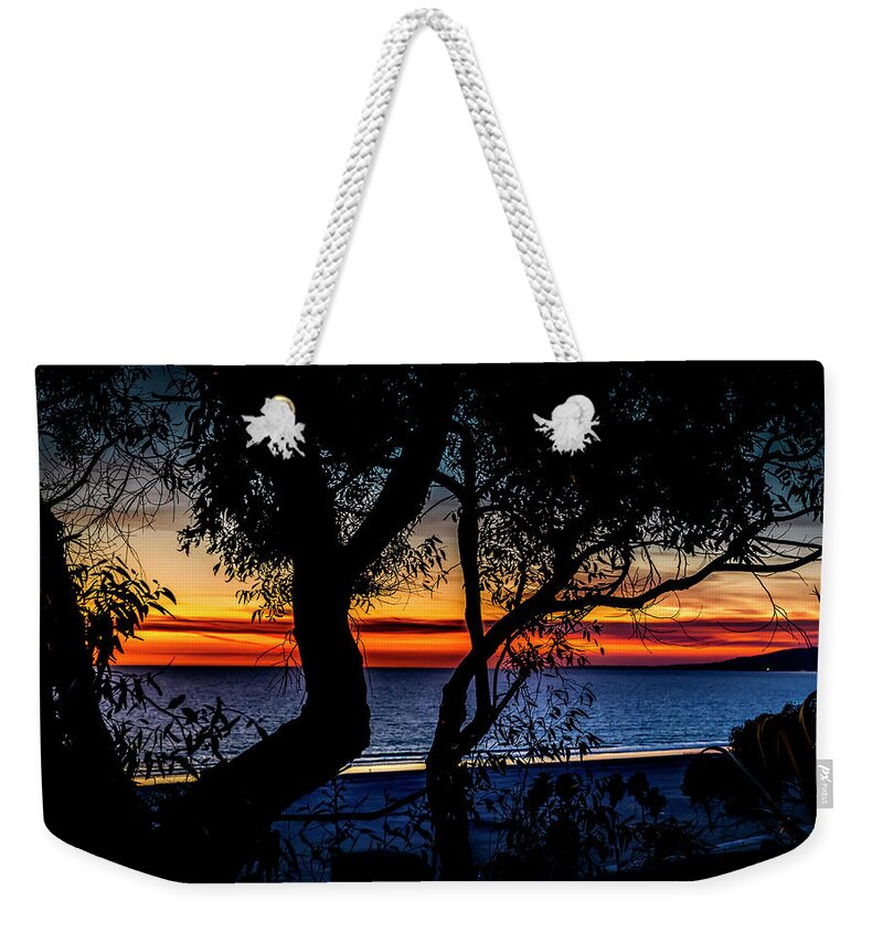 Sunset Silhouettes Weekender Tote Bag featuring the photograph Silhouettes Over Blue Water by Gene Parks