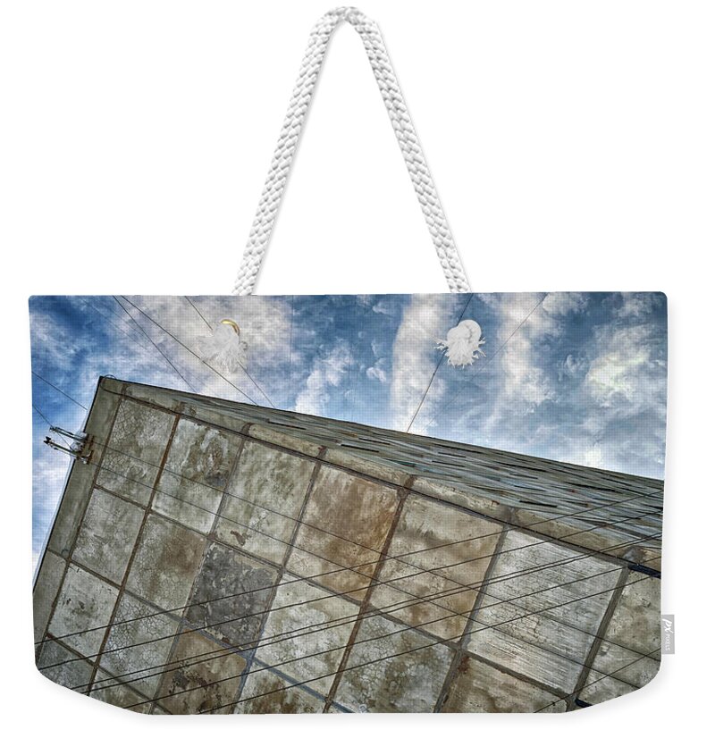 Architecture Weekender Tote Bag featuring the photograph Sinking Building Sky of Dread by John Williams