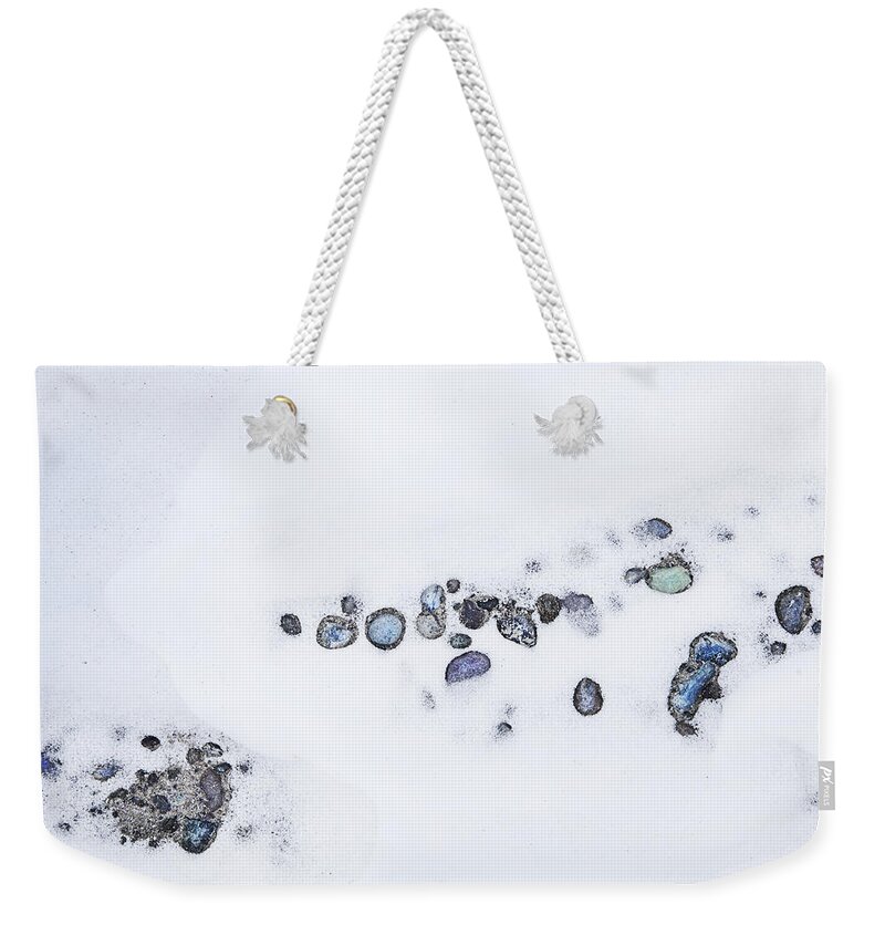 Theresa Tahara Weekender Tote Bag featuring the photograph Snow Pebbles Left by Theresa Tahara