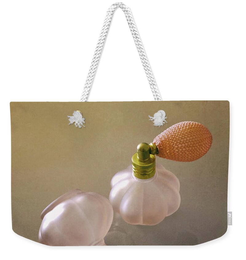 Spill Weekender Tote Bag featuring the photograph Spilled Perfume by Carlos Caetano