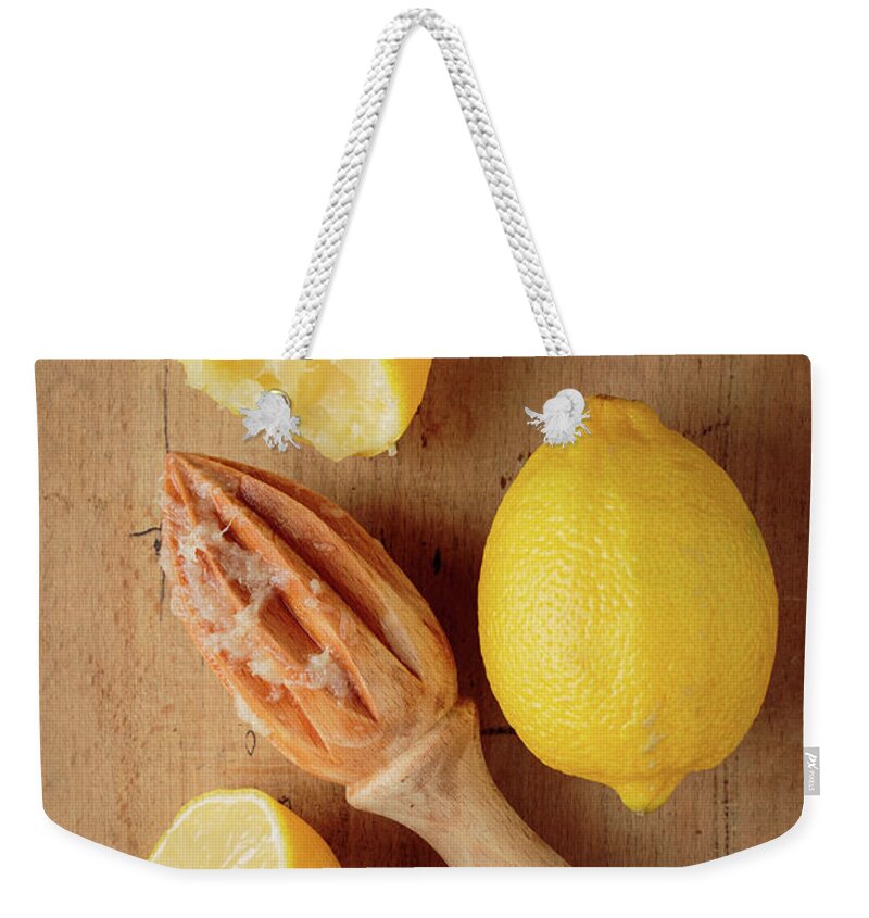 Food Weekender Tote Bag featuring the photograph Squeezed Lemons by Edward Fielding