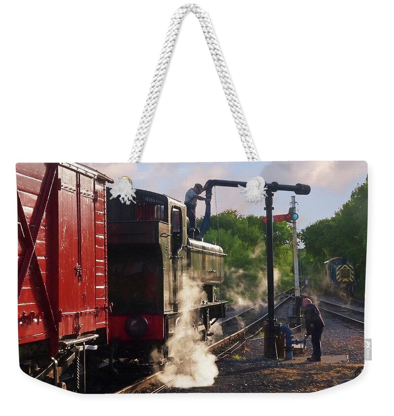 Old Steam Train Weekender Tote Bag featuring the photograph Steam Train Taking On Water by Gill Billington
