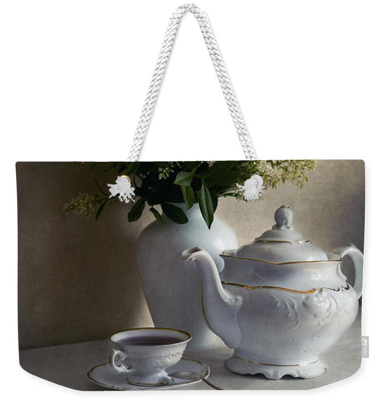 Still Life Weekender Tote Bag featuring the photograph Still life with white tea set and bouquet of white flowers by Jaroslaw Blaminsky