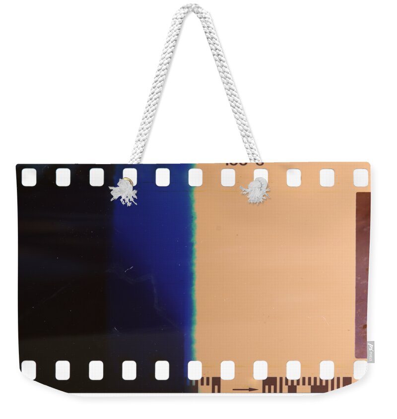 Film Weekender Tote Bag featuring the photograph Strip of the poorly exposed and developed celluloid film by Michal Boubin