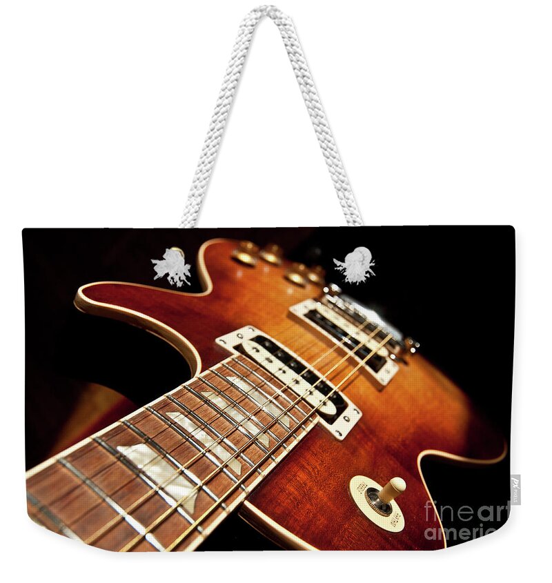 Guitar Weekender Tote Bag featuring the photograph Sunburst Electric Guitar by Iluphoto 