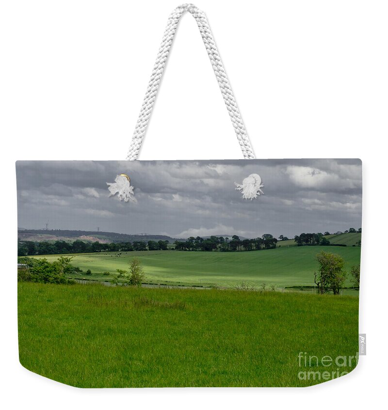 Beecraigs Weekender Tote Bag featuring the photograph Sunny patches on the field. by Elena Perelman