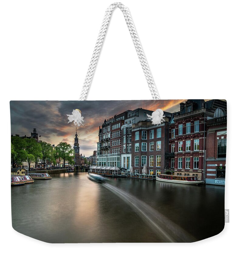 Amsterdam Weekender Tote Bag featuring the photograph Sunset on the Amstel River in Amsterdam by James Udall