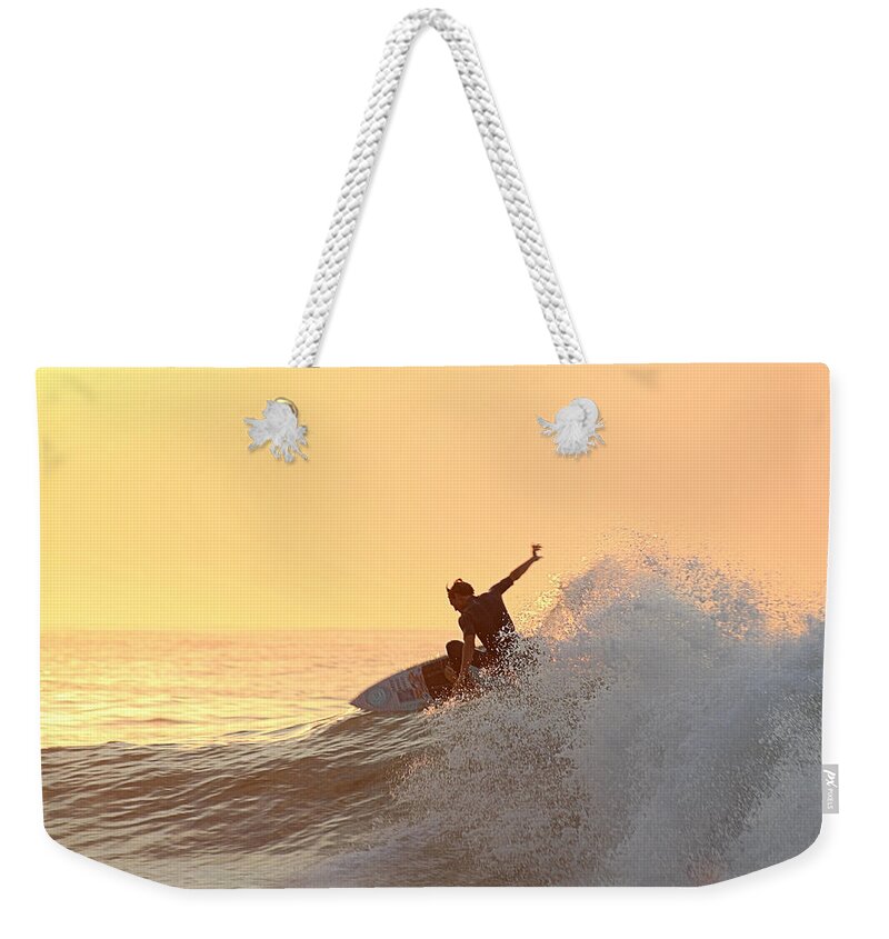 Surf Weekender Tote Bag featuring the photograph Surfing In Golden Sky by Robert Banach