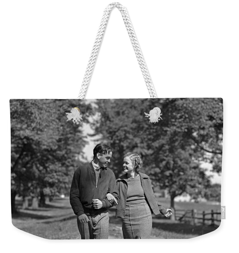 1930s Weekender Tote Bag featuring the photograph Teen Couple Out For A Walk, C.1930-40s by H. Armstrong Roberts/ClassicStock