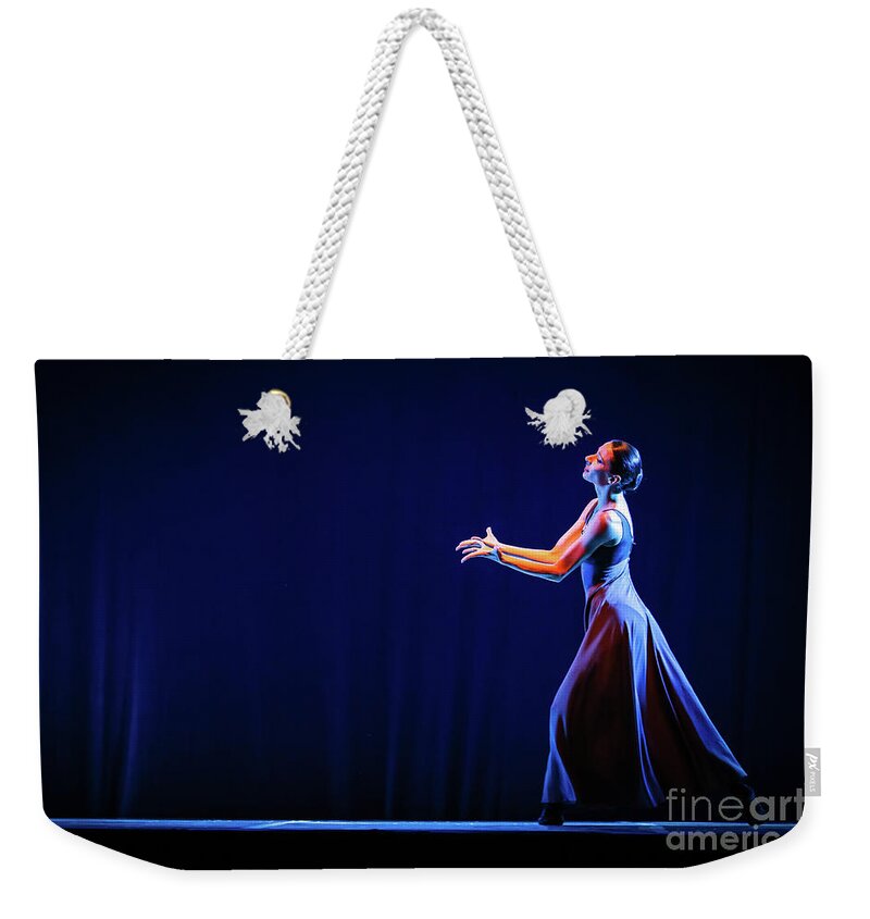 Ballet Weekender Tote Bag featuring the photograph The beautiful ballerina dancing in blue long dress by Dimitar Hristov