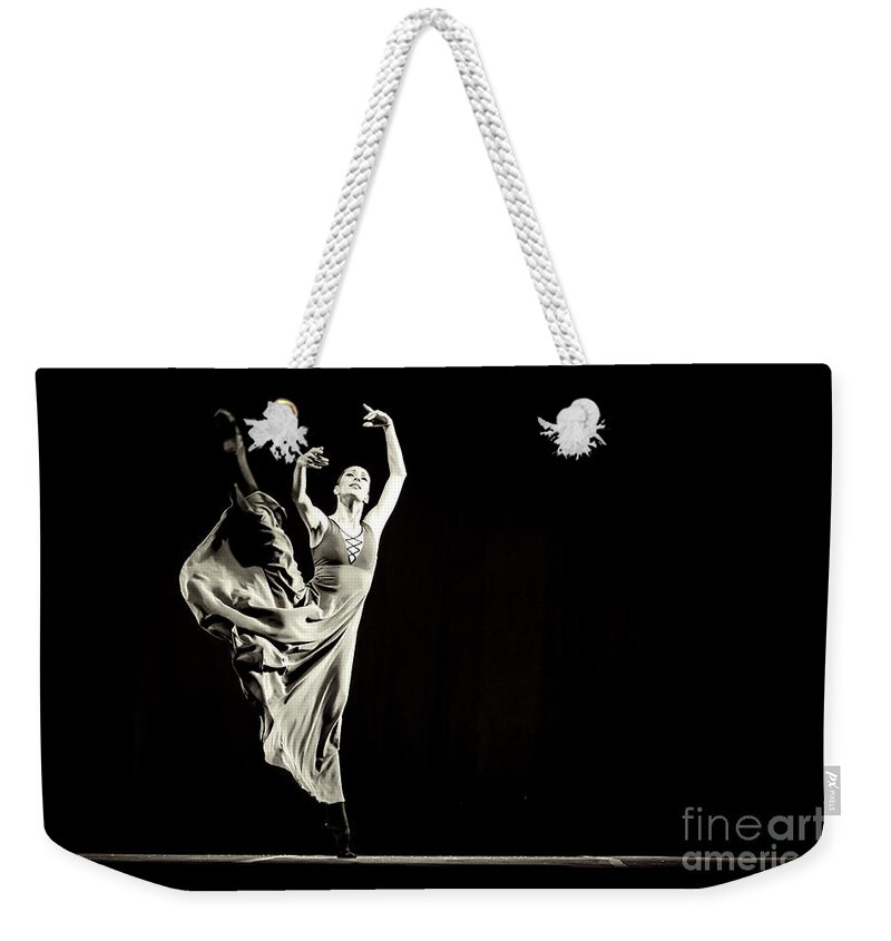 Ballet Weekender Tote Bag featuring the photograph The beautiful ballerina dancing in long dress by Dimitar Hristov