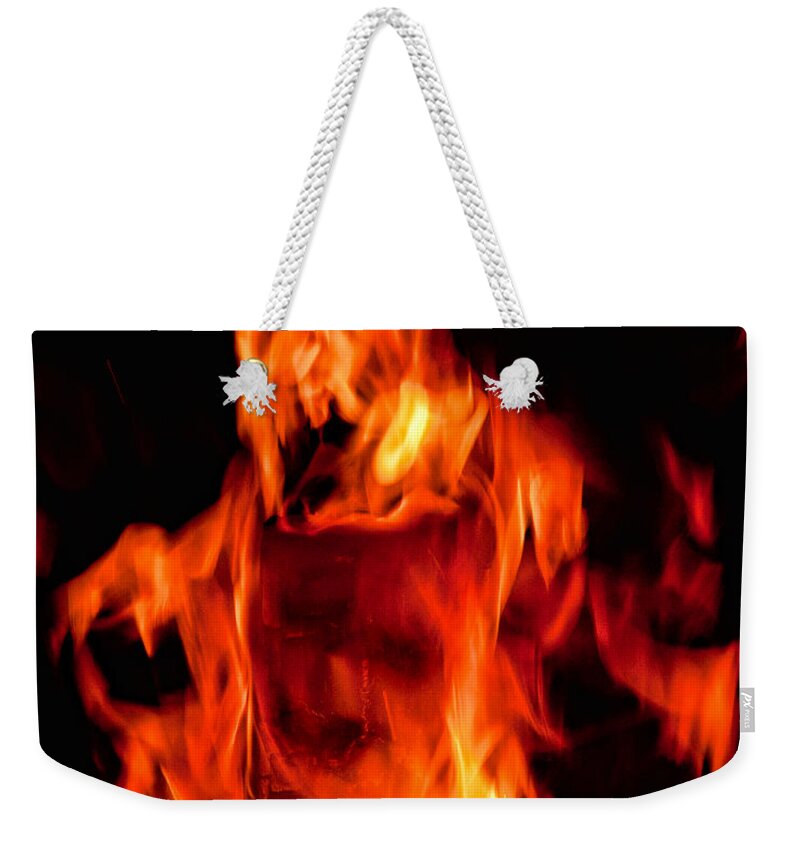Fire Weekender Tote Bag featuring the photograph The Face Of Fire by Christopher Holmes