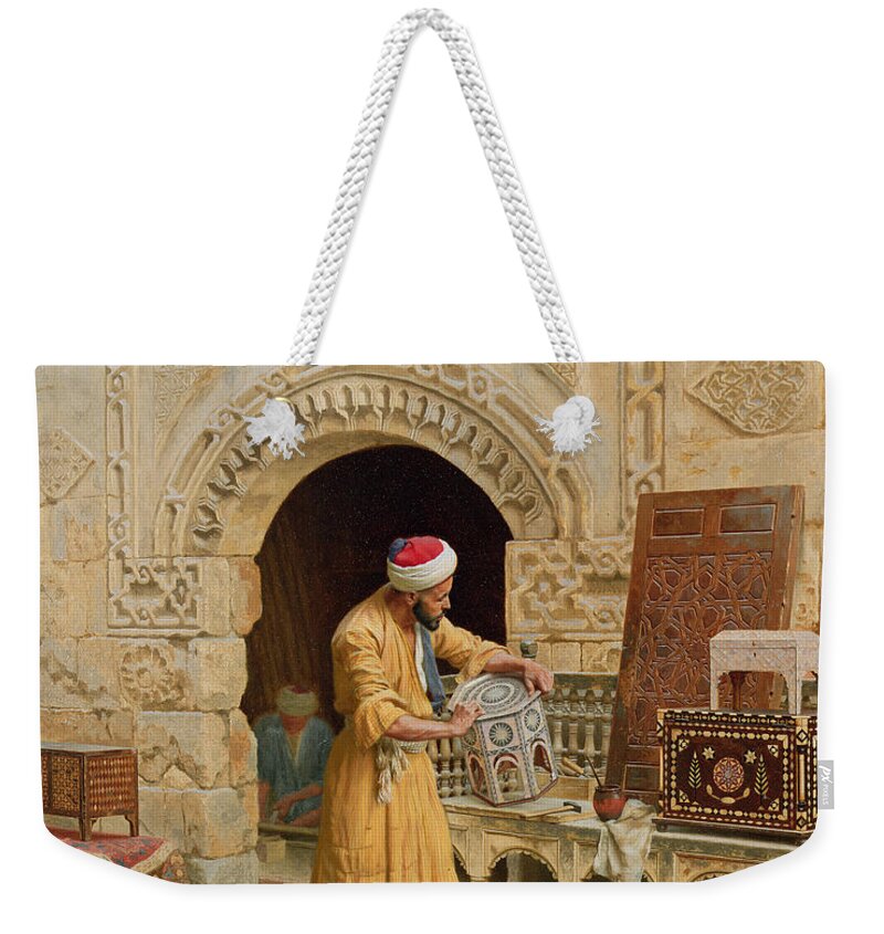 The Weekender Tote Bag featuring the painting The Furniture Maker by Ludwig Deutsch