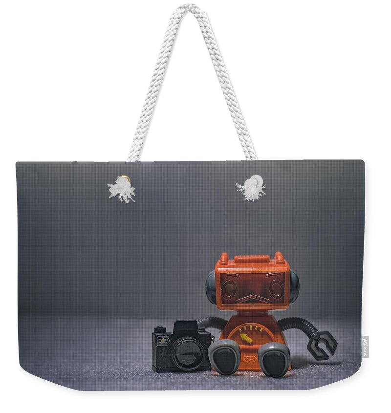 Toy Robot Weekender Tote Bag featuring the photograph The Lonely Robot Photographer by Scott Norris