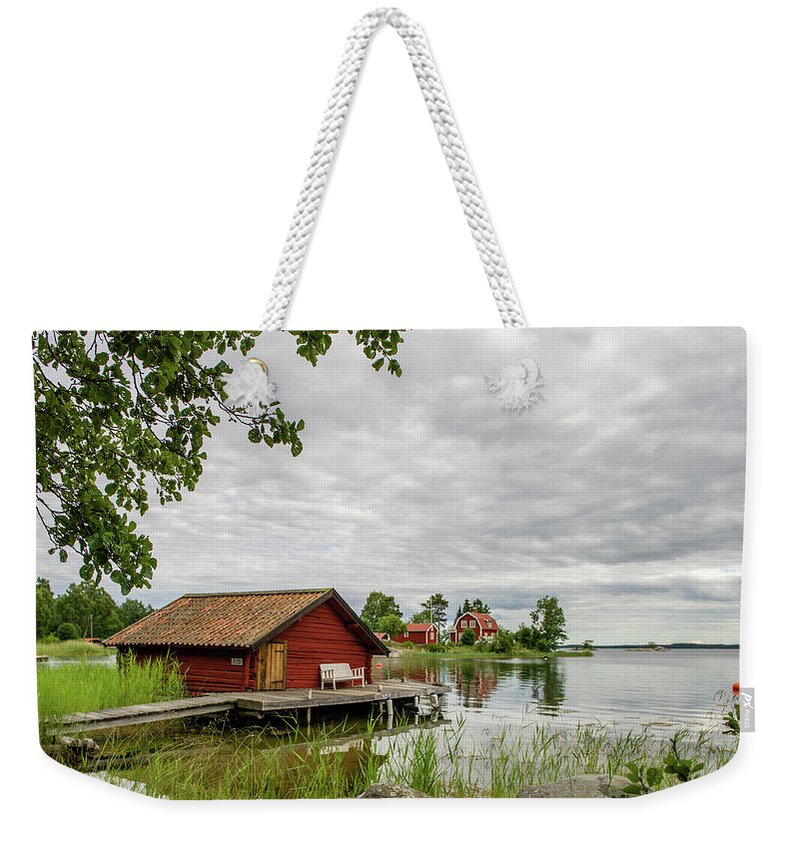 The Old Boat-house Weekender Tote Bag featuring the photograph The old boat-house by Torbjorn Swenelius