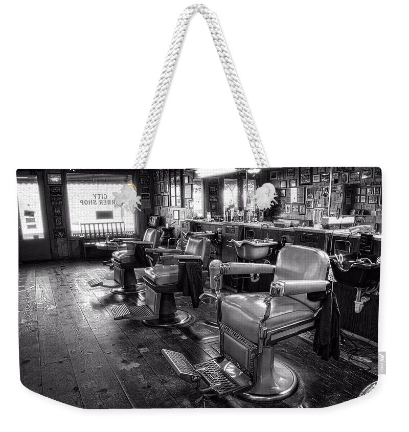Barber Chair Weekender Tote Bag featuring the photograph The Old City Barber Shop in Black and White by Greg and Chrystal Mimbs