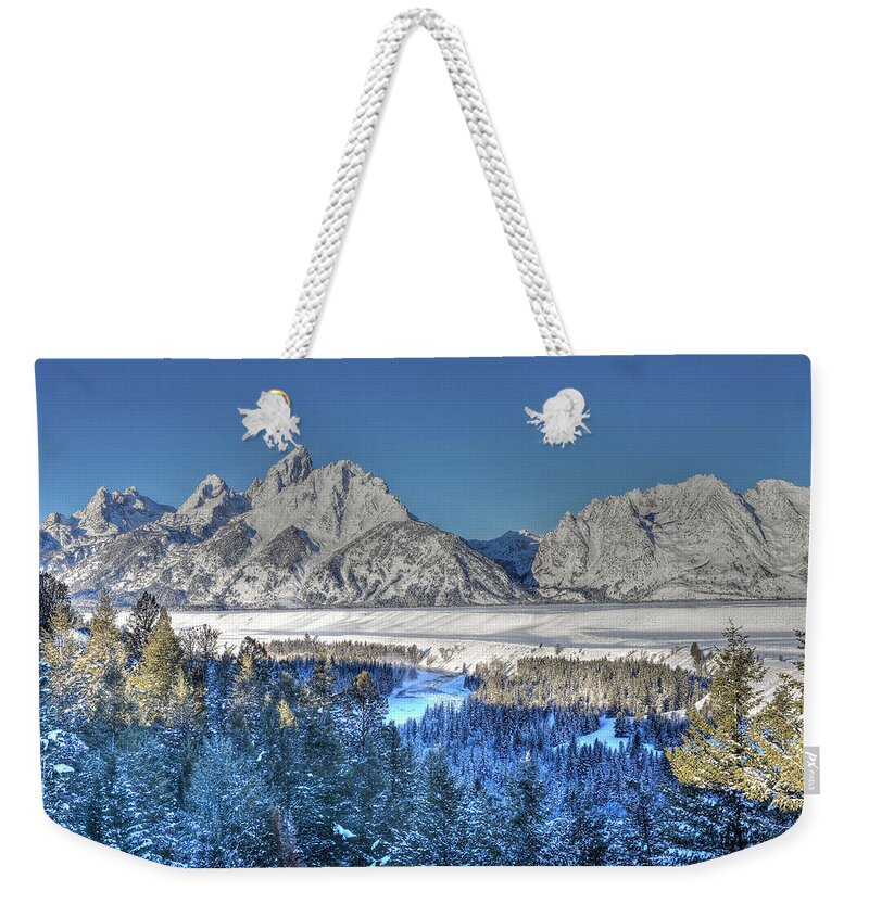 Grand Teton National Park Weekender Tote Bag featuring the photograph The Sun Rising on the Tetons by Don Mercer